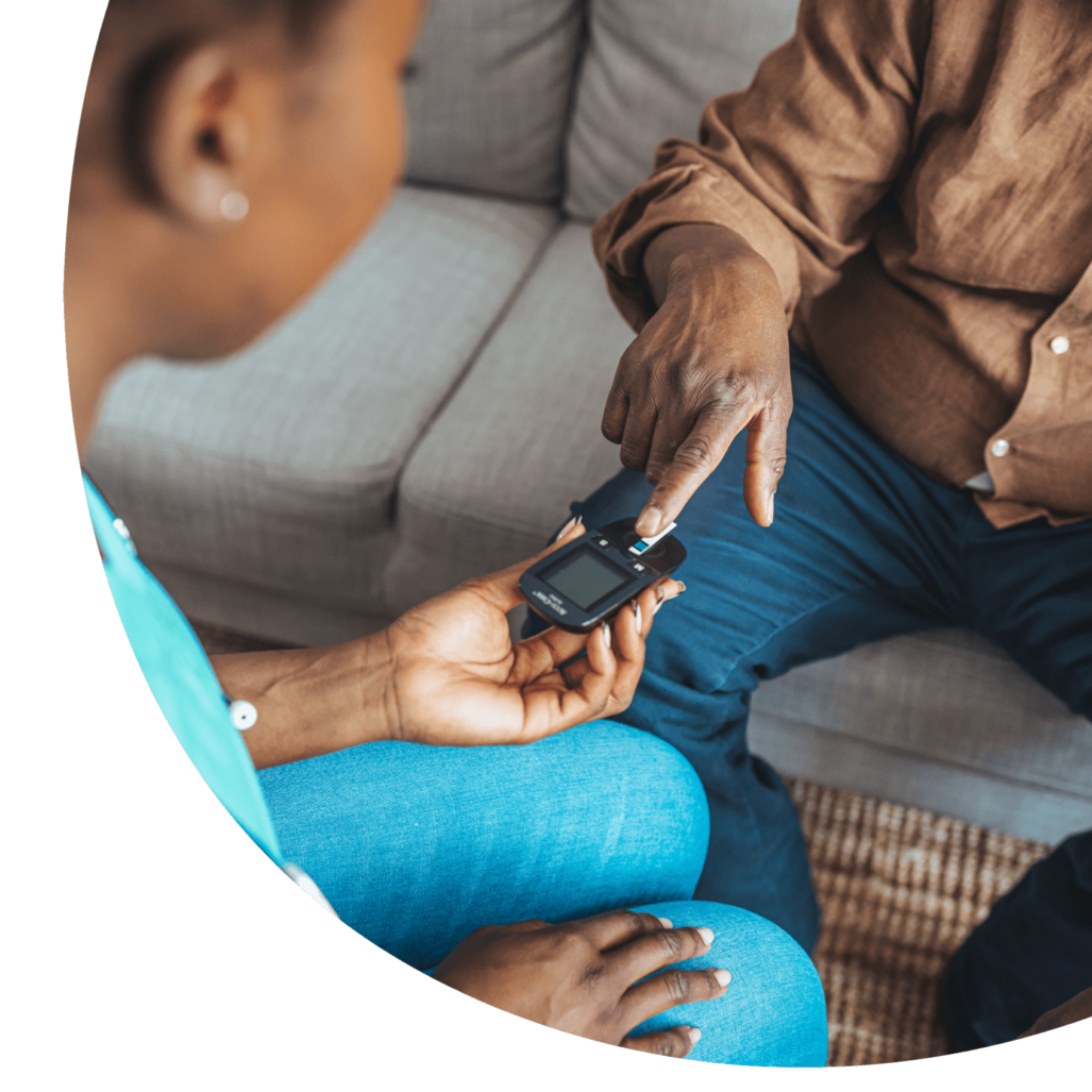 about-image Nurse Checking Patient's Blood Glucose Level